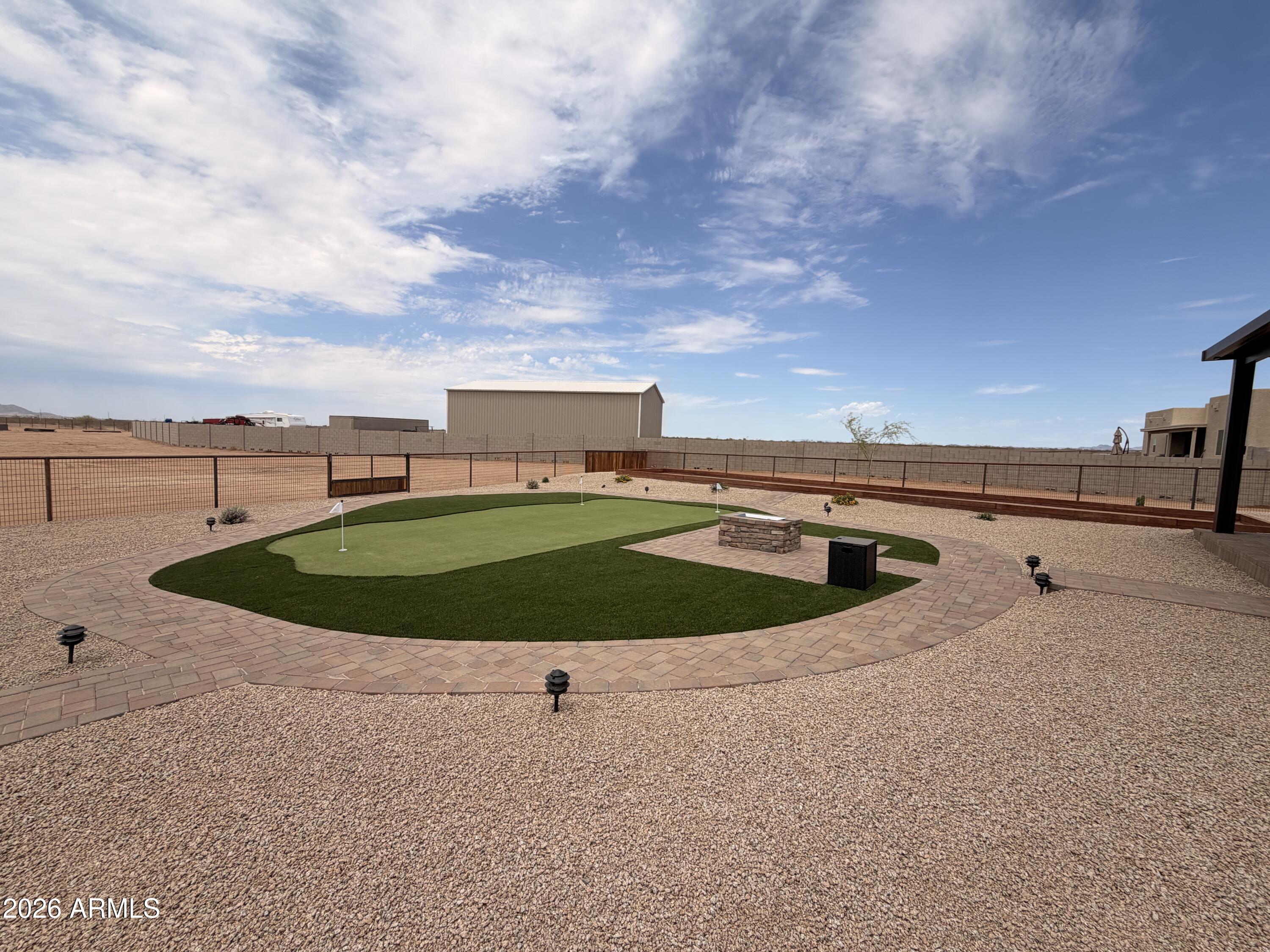 23175 West Skinner Road Wittmann, AZ 85361 - Photo 21 of 25 a view of a swimming pool with a yard