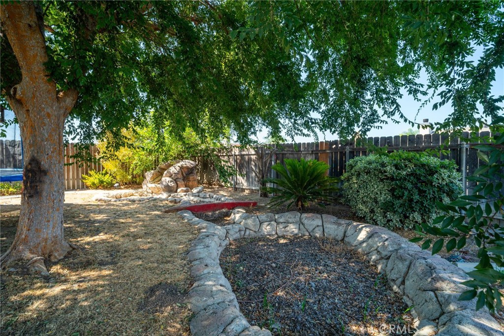 29773 Gifhorn Road Menifee, CA 92584 - Photo 19 of 25 a view of a yard with plants and trees beside of it