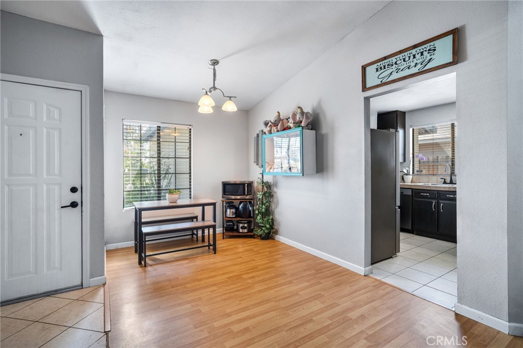 29773 Gifhorn Road Menifee, CA 92584 - Photo 4 of 25 a view of a livingroom with furniture cabinet wooden floor and a chandelier