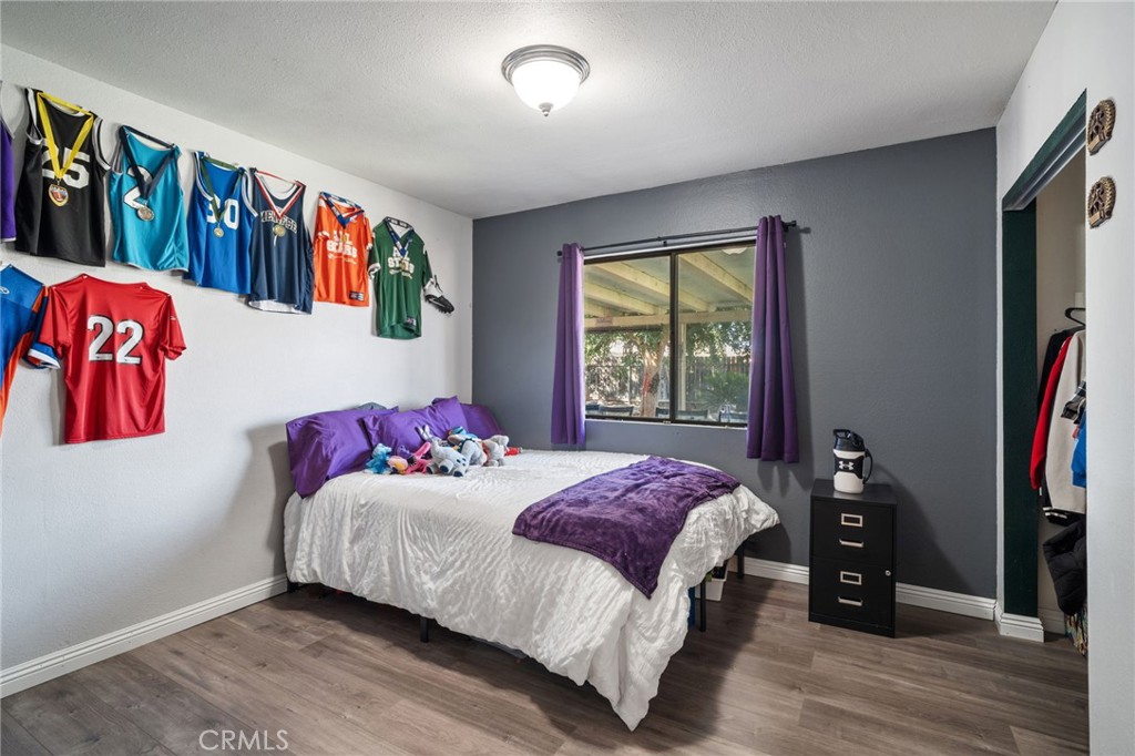 29773 Gifhorn Road Menifee, CA 92584 - Photo 9 of 25 a bedroom with a bed and a large window