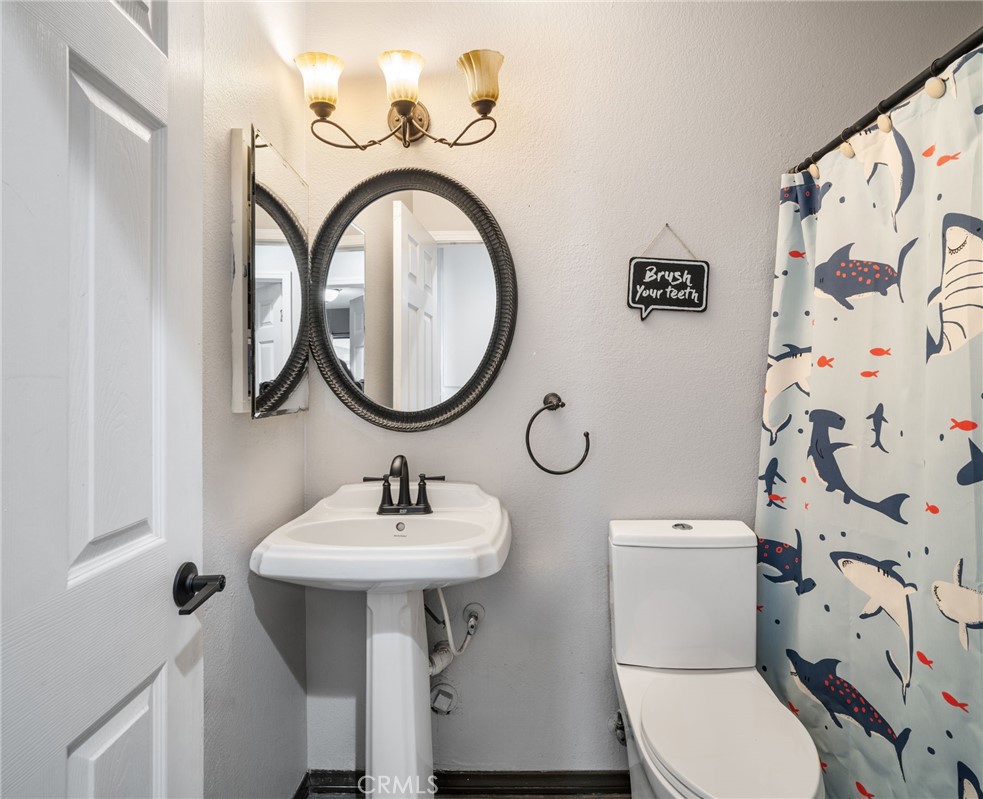 29773 Gifhorn Road Menifee, CA 92584 - Photo 10 of 25 a bathroom with a sink and a mirror