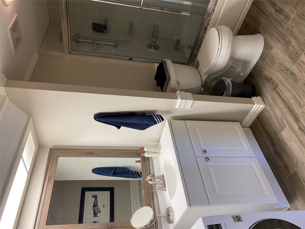 1122 Colorado Street, Unit 1802 Austin, TX 78701 - Photo 3 of 9 a bathroom with a sink toilet and shower