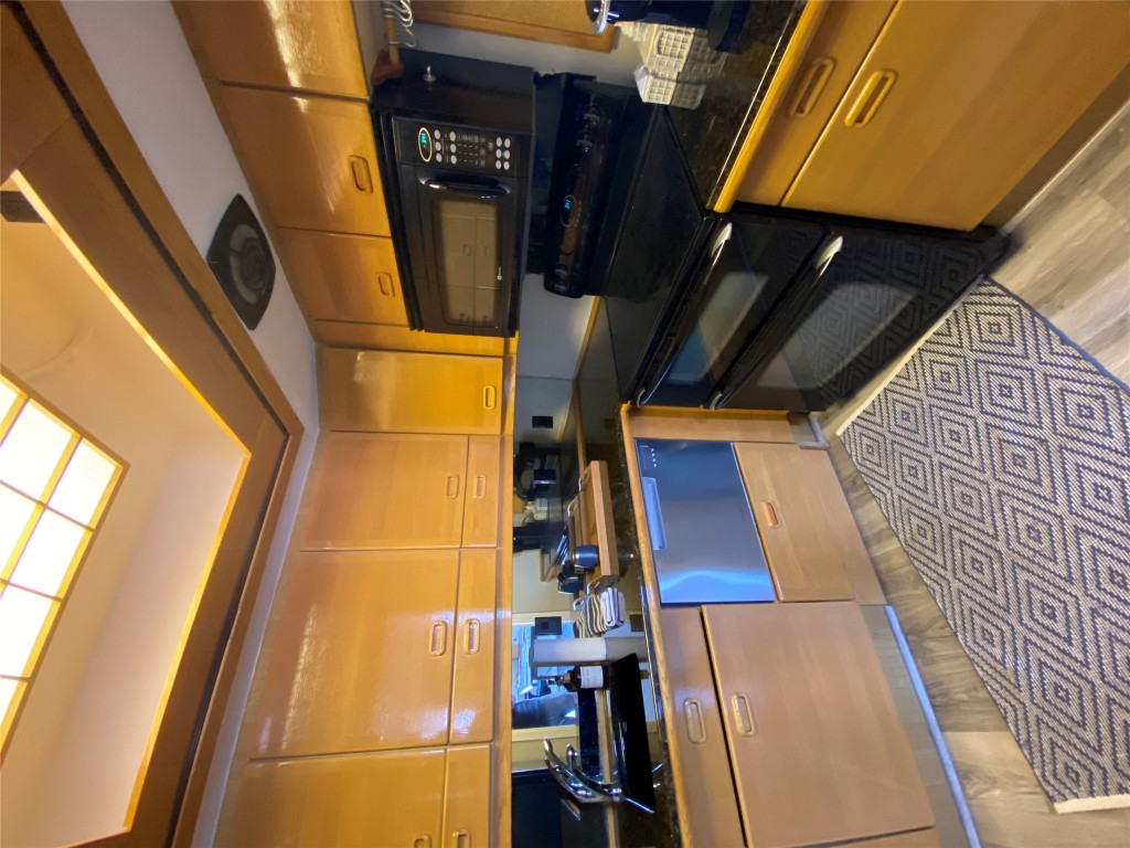 1122 Colorado Street, Unit 1802 Austin, TX 78701 - Photo 9 of 9 a kitchen with stainless steel appliances granite countertop a stove a sink and a microwave