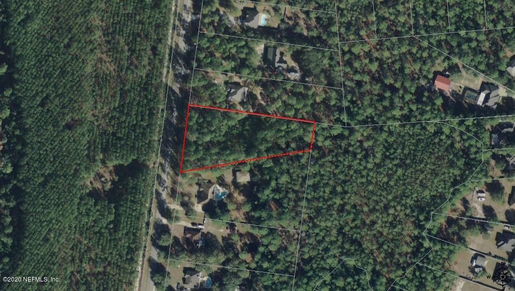 an aerial view of residential house with outdoor space and trees all around