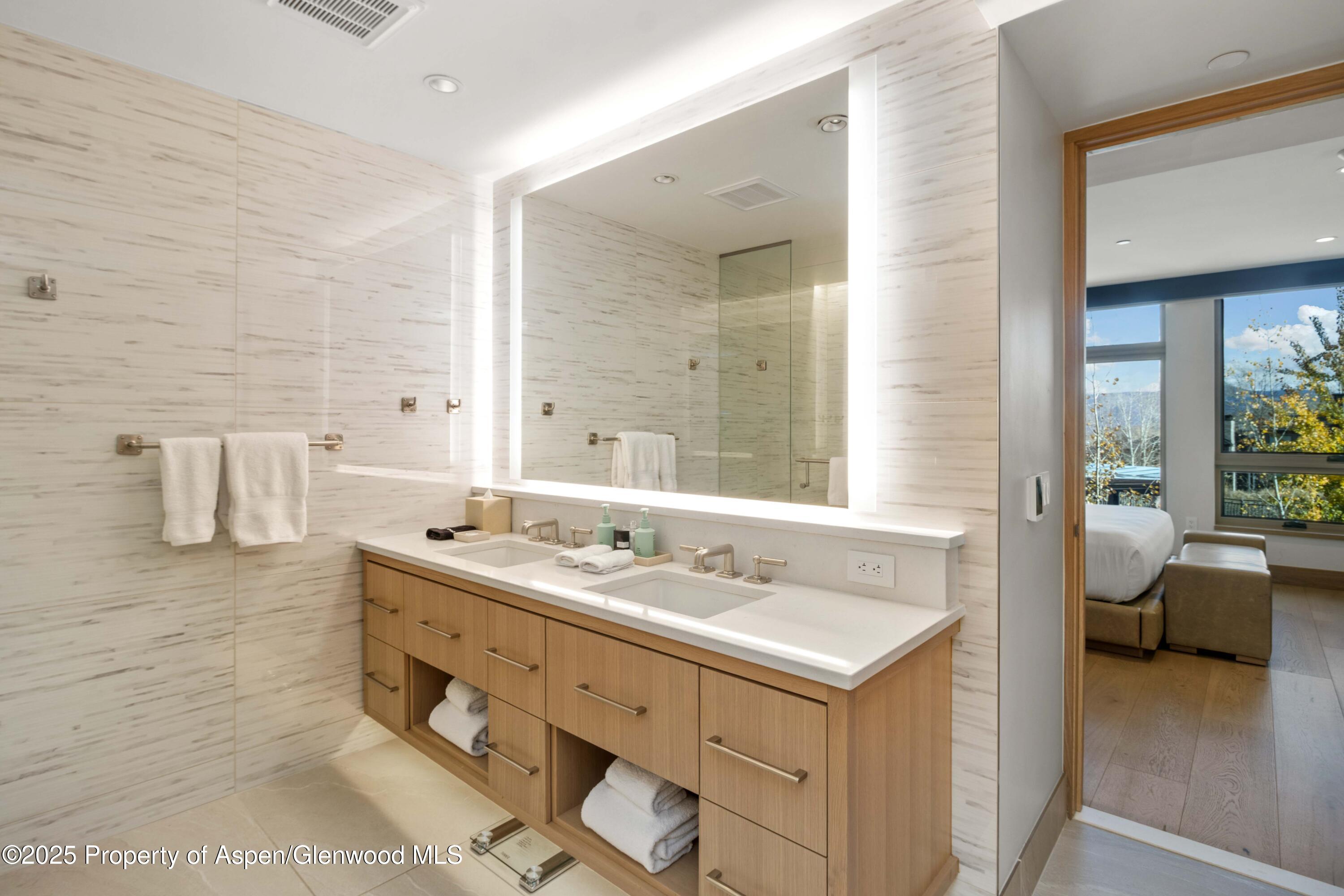 130 Wood Road, Unit 151 Snowmass Village, CO 81615 - Photo 13 of 16 a bathroom with a sink double vanity and a mirror