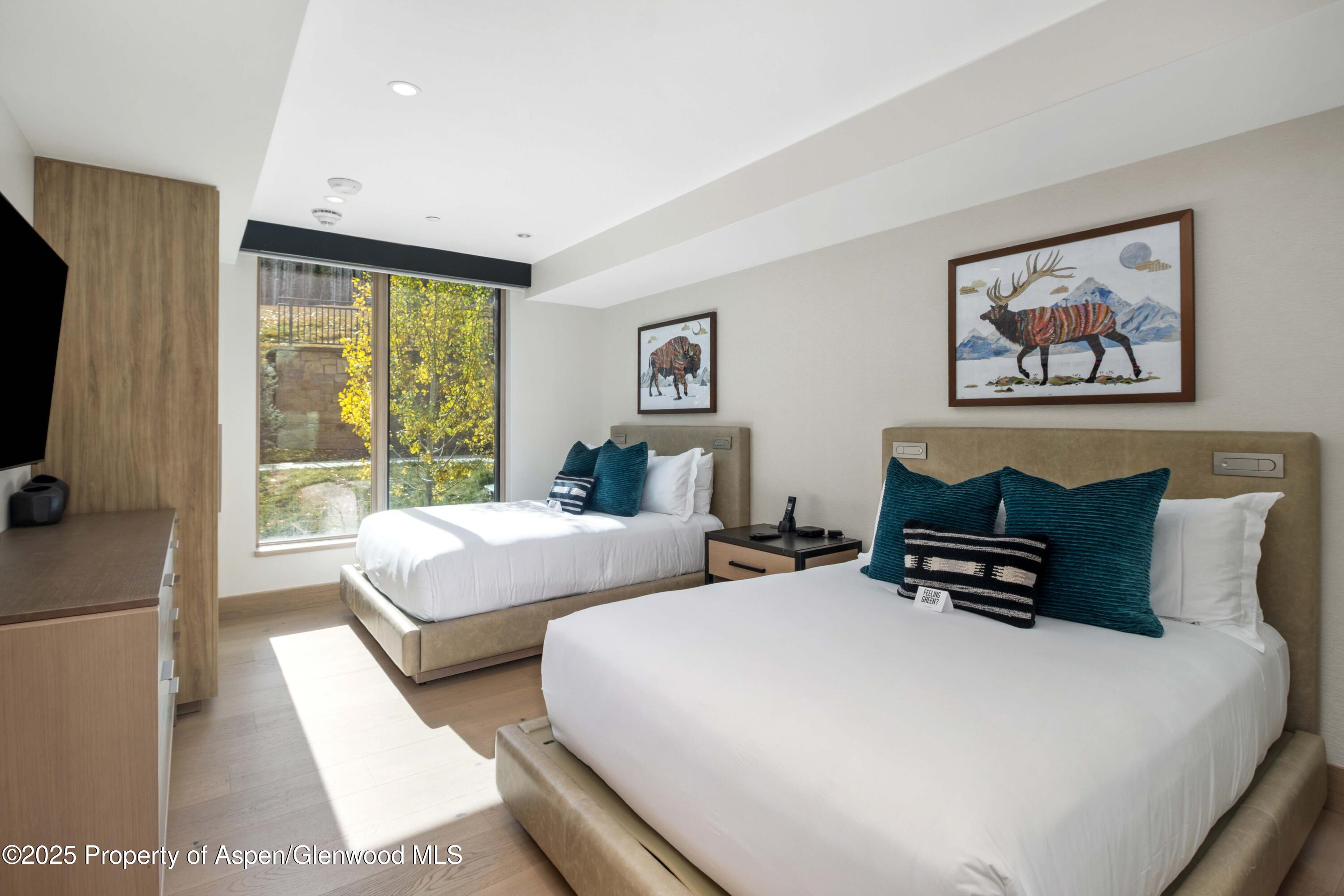 130 Wood Road, Unit 151 Snowmass Village, CO 81615 - Photo 15 of 16 a bedroom with bed and large window