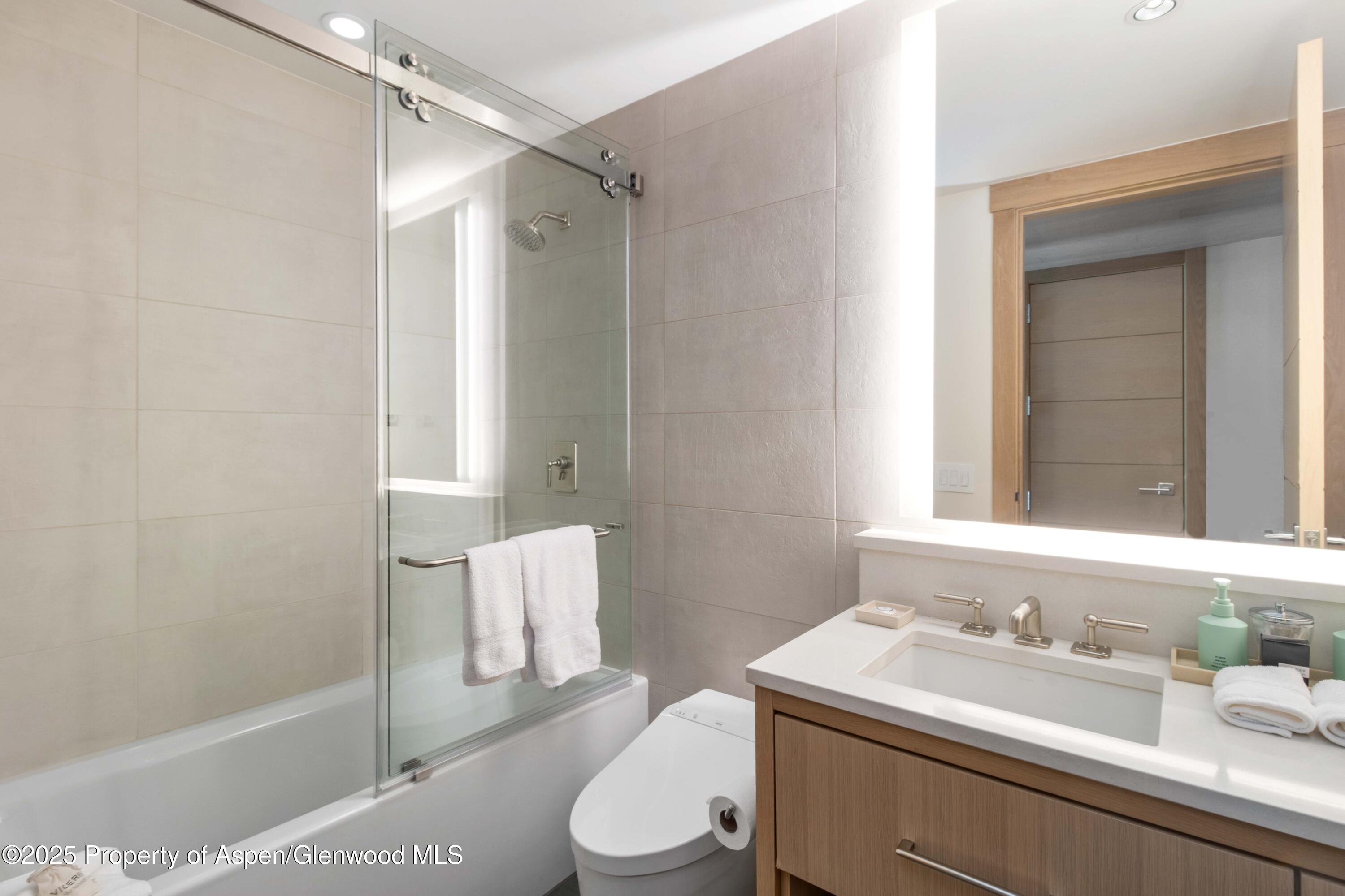 130 Wood Road, Unit 151 Snowmass Village, CO 81615 - Photo 16 of 16 a bathroom with a sink toilet vanity and tub