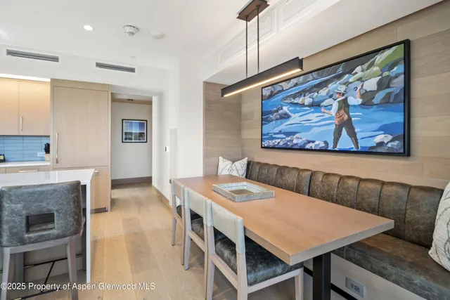 a view of a dining room with furniture wooden floor and a fireplace