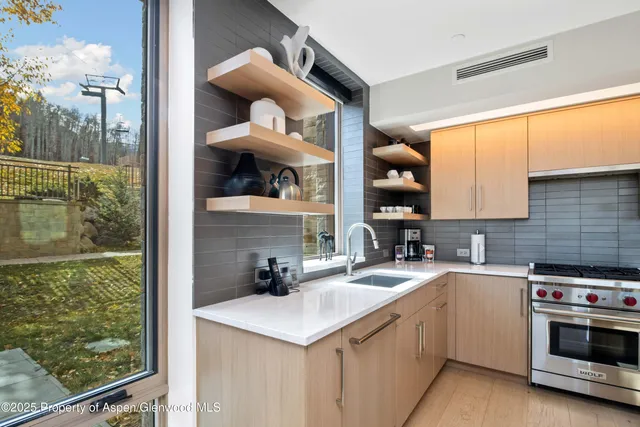 a bedroom with a bed and glass window