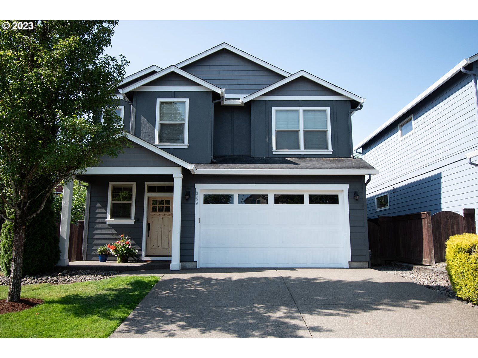 4309 North 4th Circle Ridgefield, WA 98642 - Photo 1 of 24 a front view of a house with a garden and trees