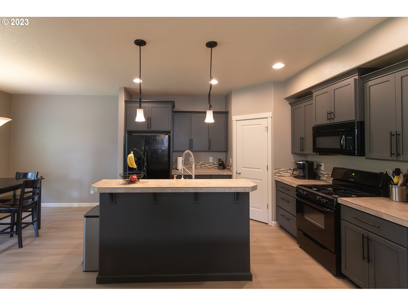 4309 North 4th Circle Ridgefield, WA 98642 - Photo 3 of 24 a kitchen with stainless steel appliances granite countertop a sink a stove top oven a counter space and cabinets