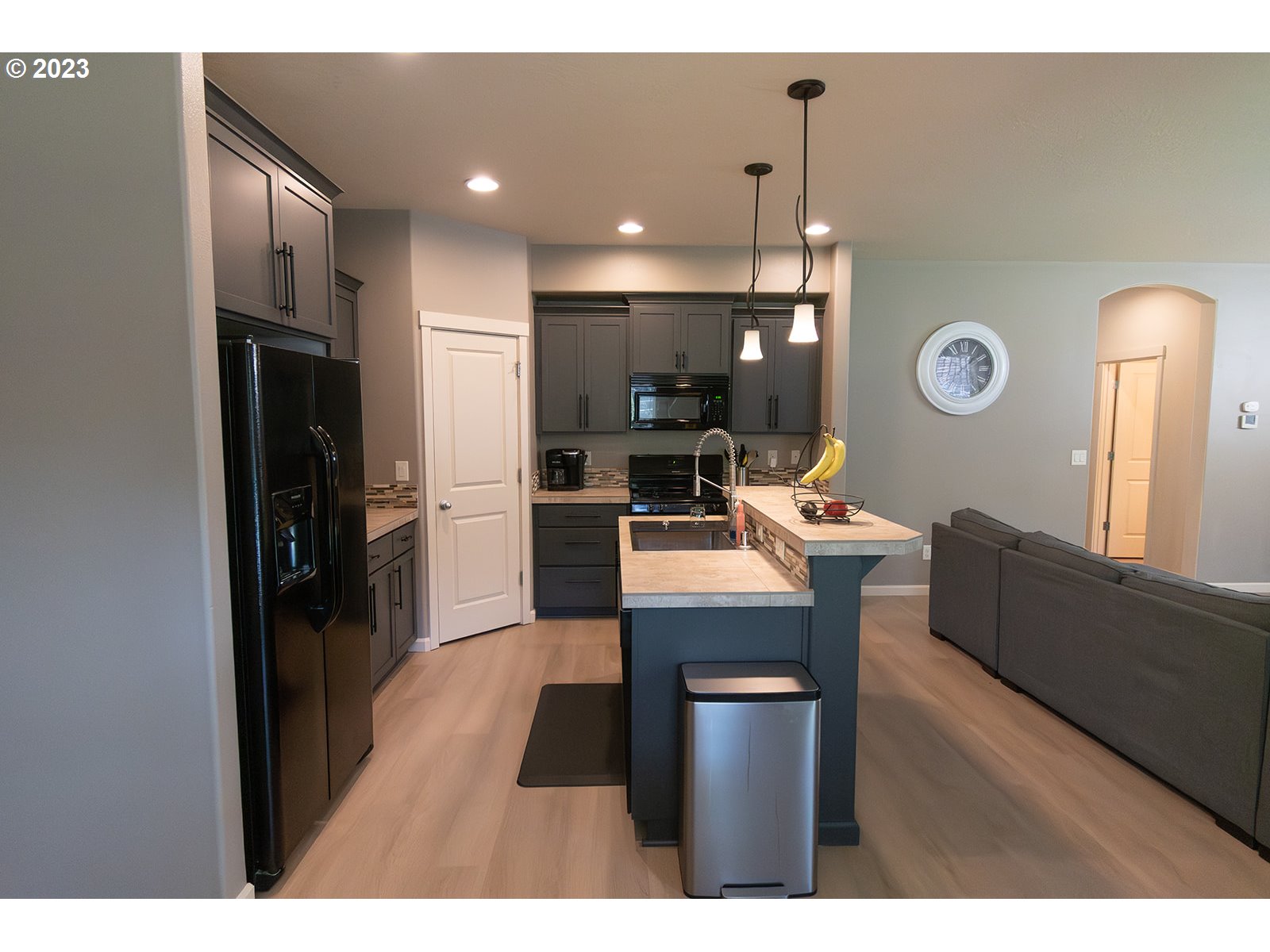 4309 North 4th Circle Ridgefield, WA 98642 - Photo 4 of 24 a living room with stainless steel appliances kitchen island granite countertop furniture and a view of kitchen