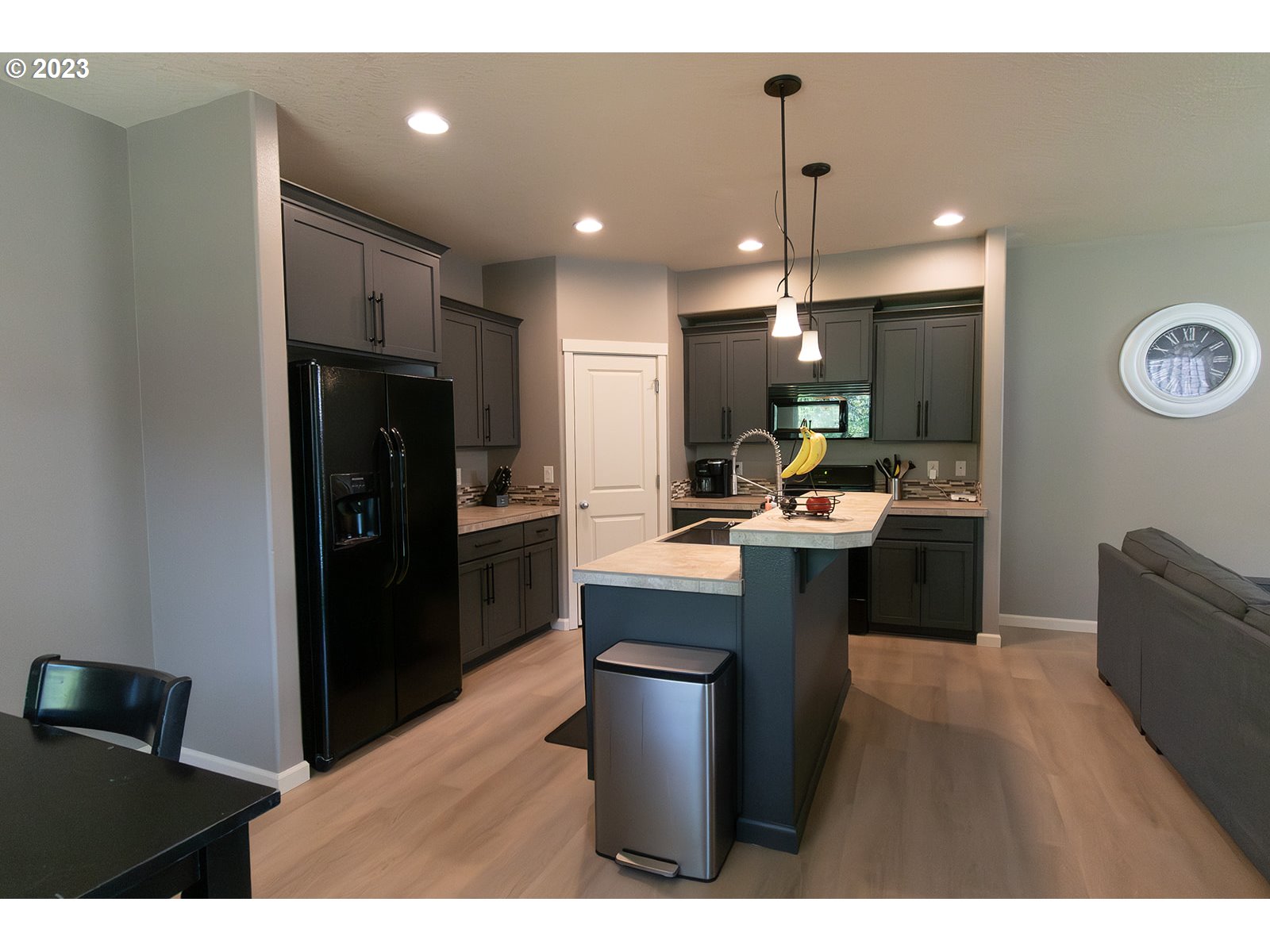 4309 North 4th Circle Ridgefield, WA 98642 - Photo 5 of 24 a kitchen with kitchen island stainless steel appliances a sink cabinets and wooden floor