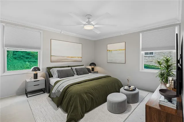 a bedroom with a bed and a large window