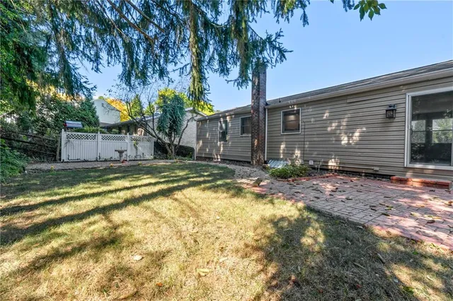 a house view with swimming pool in front of it