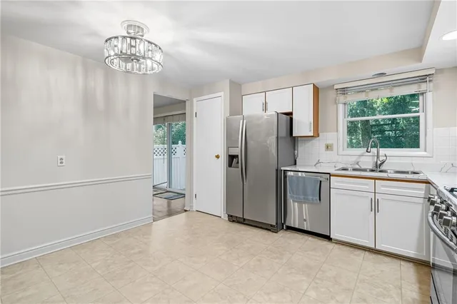 a kitchen with stainless steel appliances a refrigerator and a sink