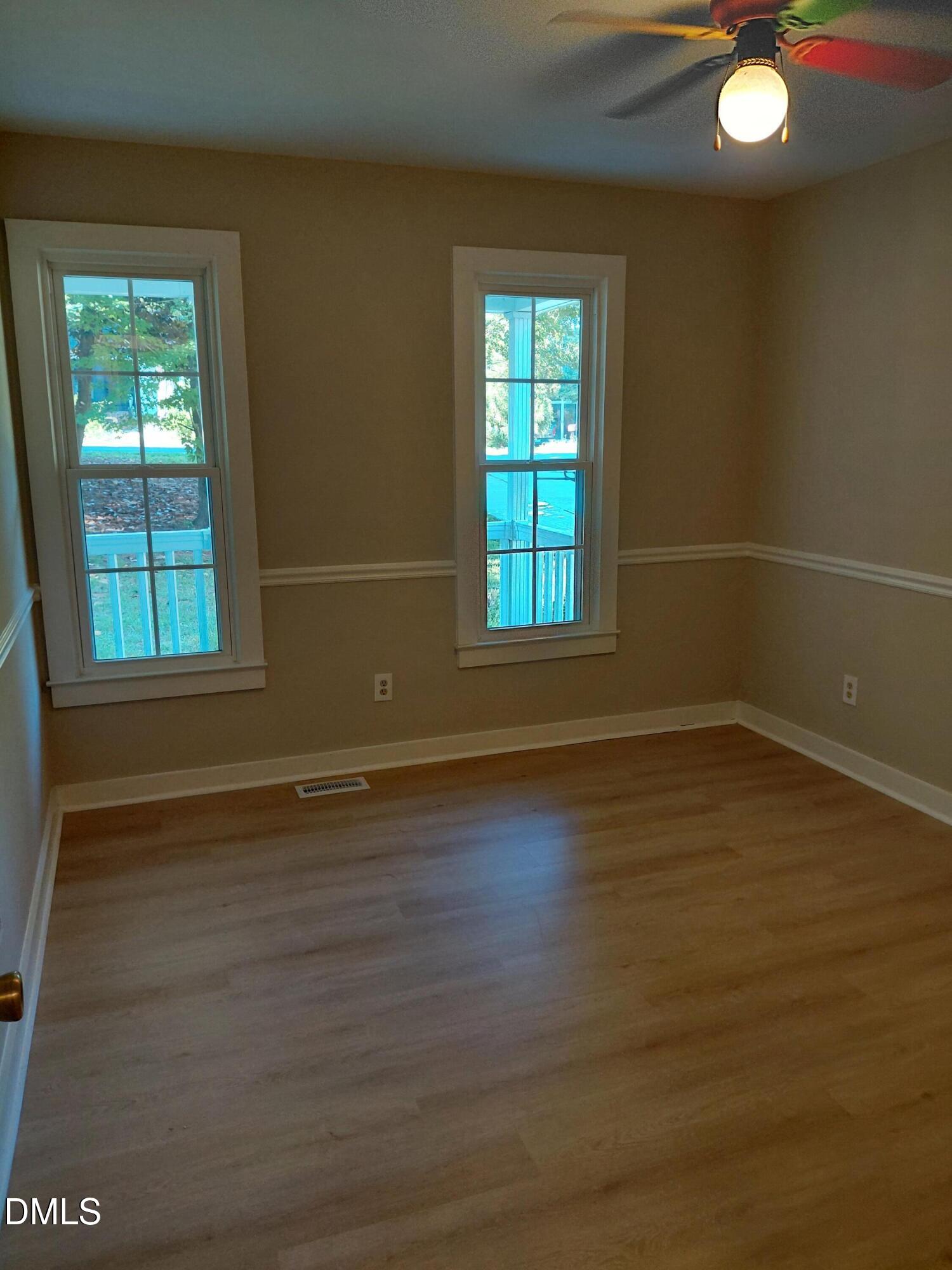 804 Olive Street Apex, NC 27502 - Photo 55 of 60 an empty room with wooden floor and windows