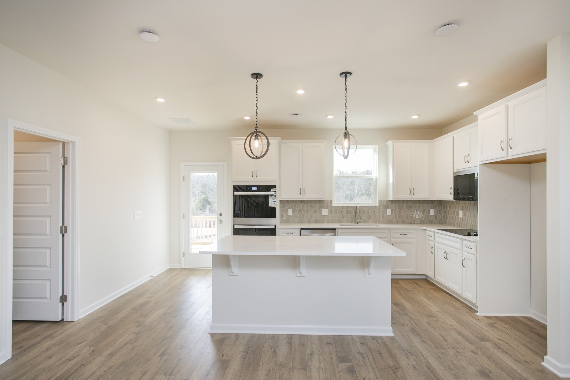 1308 Godwin Road Hermitage, TN 37076 - Photo 18 of 45 a large kitchen with kitchen island a stove a sink a center island and wooden floor
