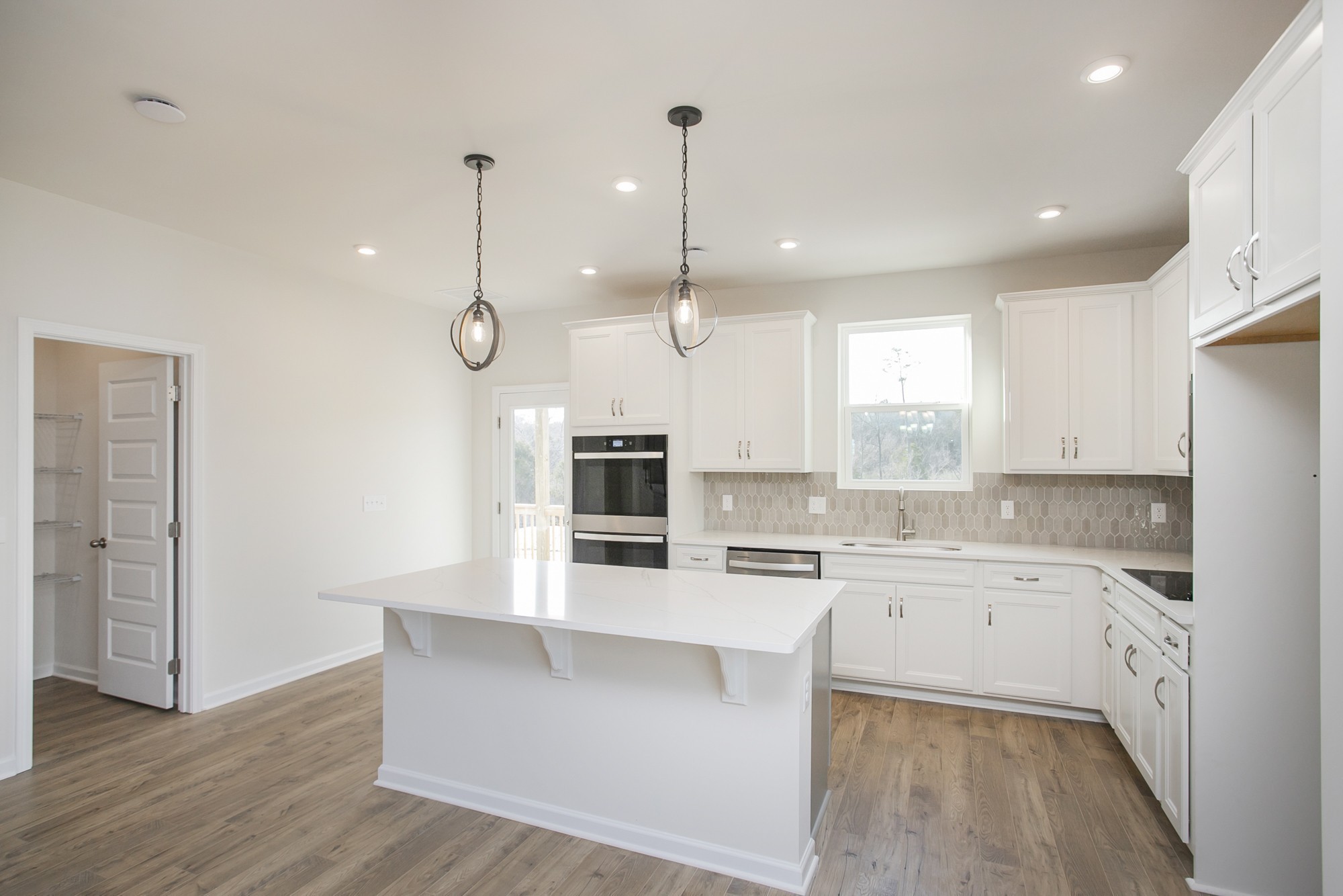 1308 Godwin Road Hermitage, TN 37076 - Photo 19 of 45 a large kitchen with kitchen island a stove a sink a center island and wooden floor