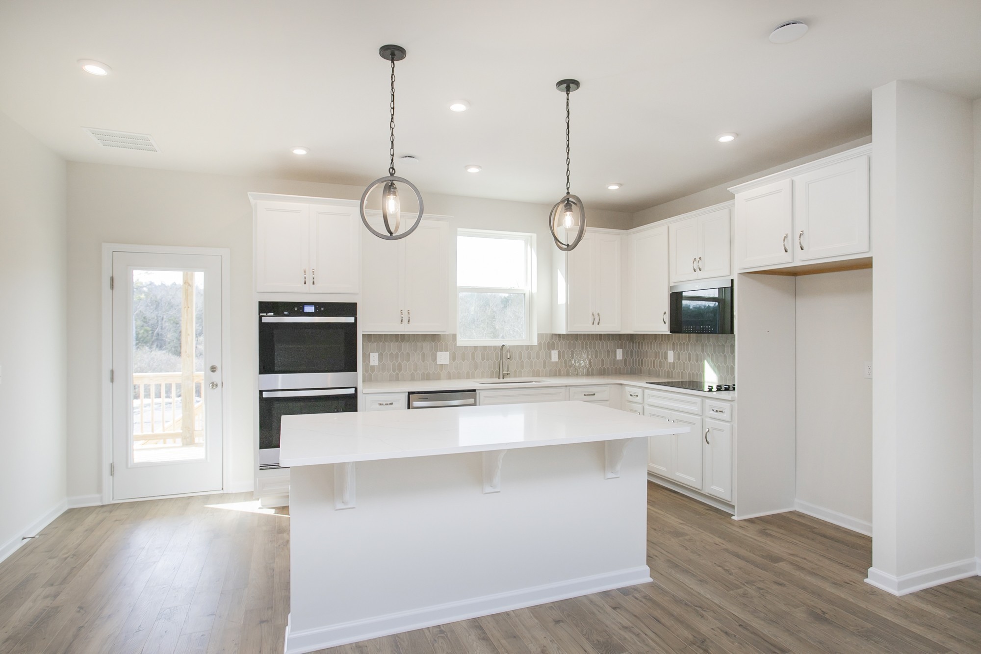 1308 Godwin Road Hermitage, TN 37076 - Photo 20 of 45 a large kitchen with stainless steel appliances kitchen island granite countertop a stove a sink a center island a refrigerator and a wooden floor