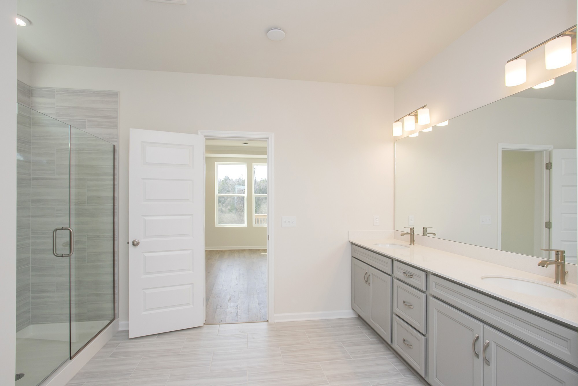 1308 Godwin Road Hermitage, TN 37076 - Photo 25 of 45 a bathroom with a double vanity sink a mirror and a shower