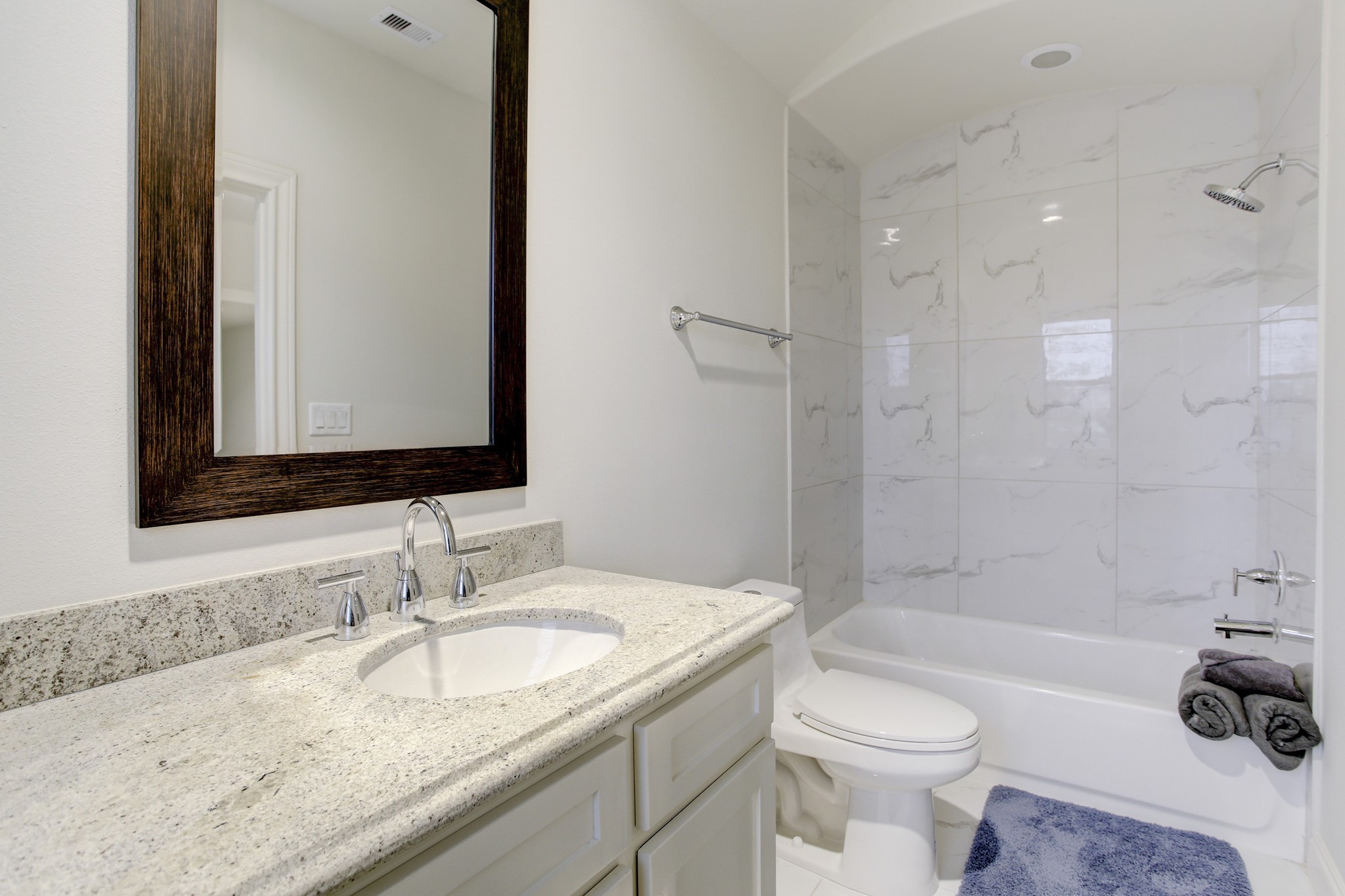 5506 Darling Street Houston, TX 77007 - Photo 21 of 23 The lovely 3rd Floor Bathroom has a shower/tub clad in tile with a barrel ceiling, and a wide vanity with a stunning granite countertop.