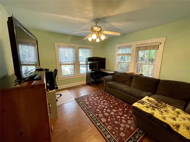 a living room with furniture and a flat screen tv