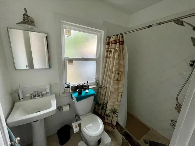 a white toilet sitting next to a bathroom sink