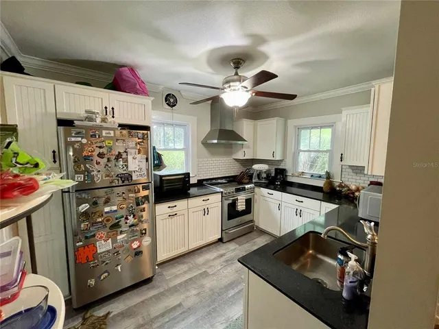 a kitchen with a sink appliances and cabinets