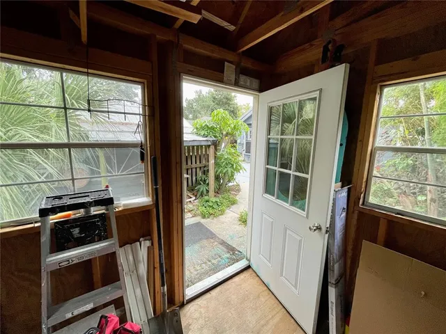 a view of a house with backyard and sitting area
