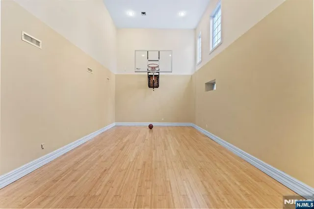 a view of a patio with table and chairs potted plants with floor to ceiling window