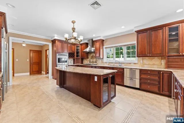 a kitchen with stainless steel appliances granite countertop a stove and a sink