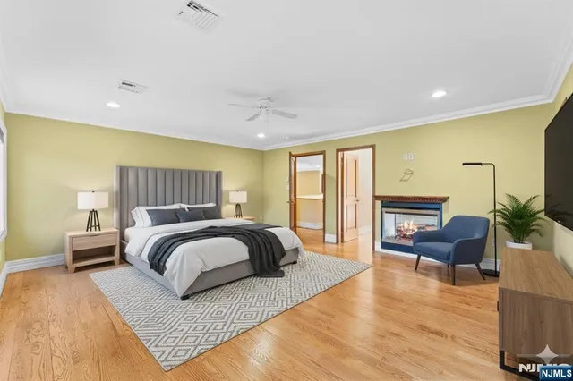 a spacious bedroom with a large bed and wooden floor