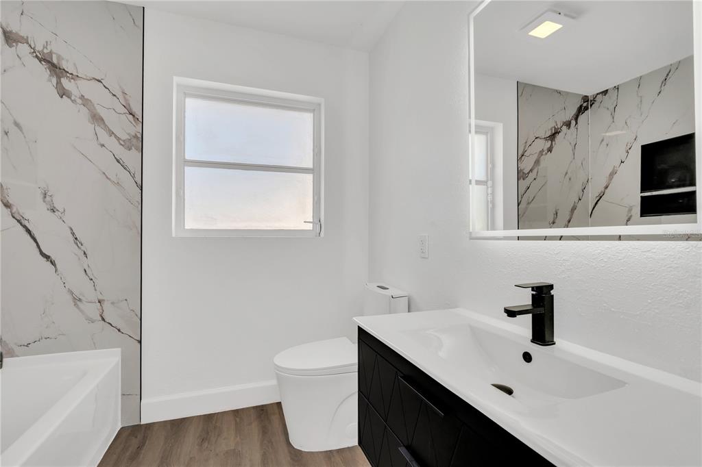 11598 Ridge Road Largo, FL 33778 - Photo 13 of 29 a bathroom with a sink toilet and shower