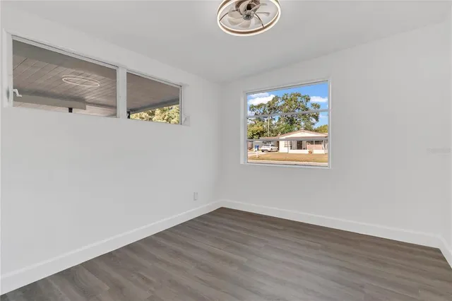a view of a hallway with wooden floor and front door