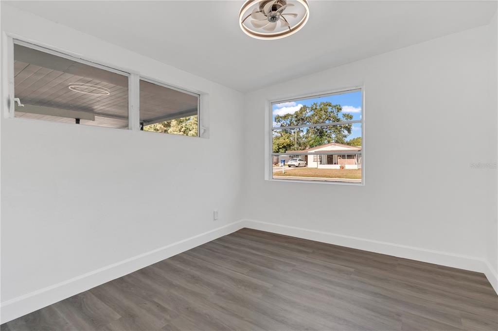 11598 Ridge Road Largo, FL 33778 - Photo 19 of 29 a view of a hallway with wooden floor and front door