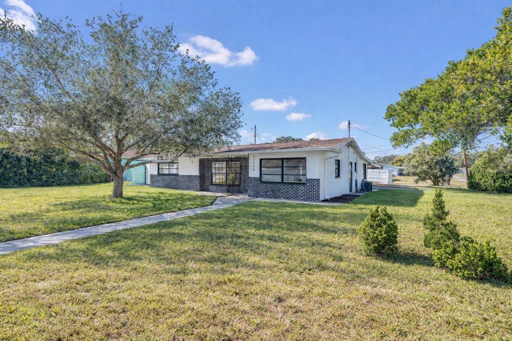 11598 Ridge Road Largo, FL 33778 - Photo 27 of 29 a view of a house with backyard and garden