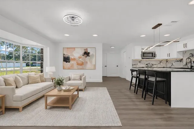 a living room with furniture and wooden floor