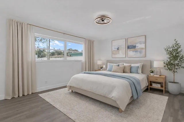 a bedroom with a bed and a window