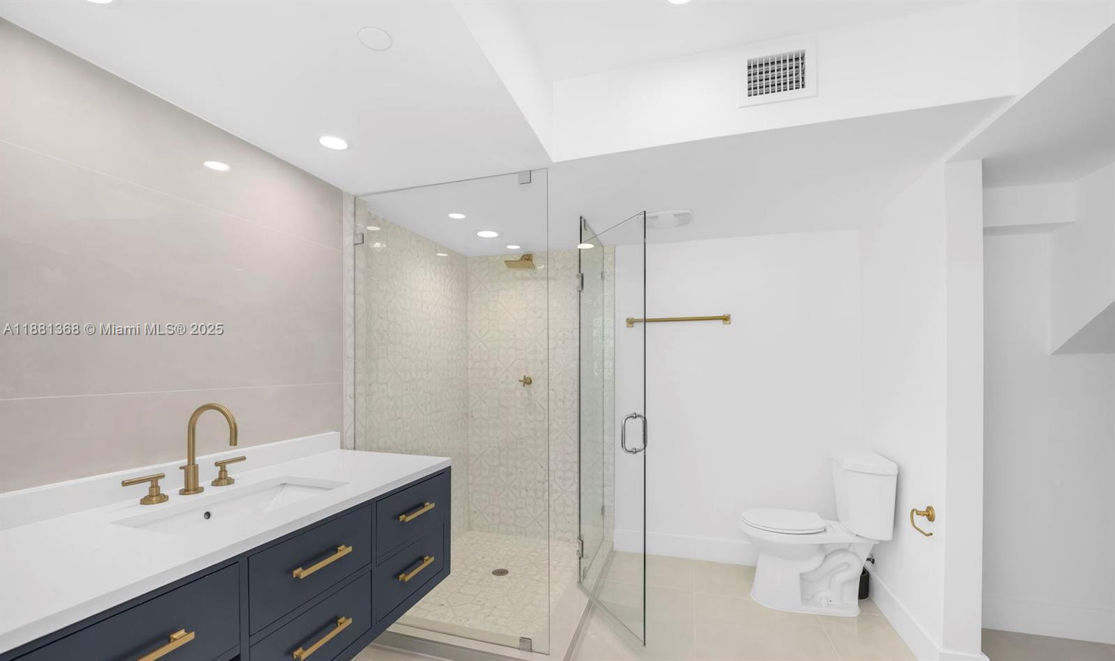 221 Jefferson Avenue, Unit 10 Miami Beach, FL 33139 - Photo 9 of 17 a bathroom with a toilet a sink and mirror