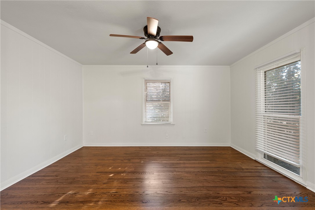 1203 South 5th Street Temple, TX 76504 - Photo 24 of 29 a view of empty room with wooden floor and fan