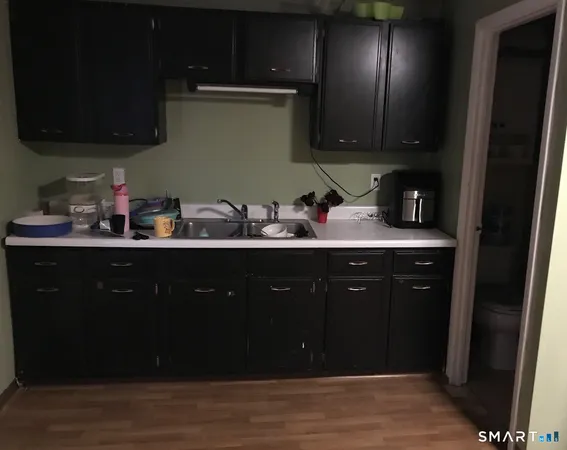 a view of a workspace with furniture and wooden floor