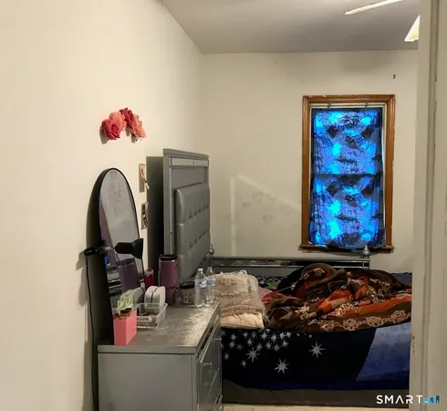 a bedroom with a bed and a window