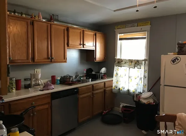 a kitchen with a sink cabinets and a window