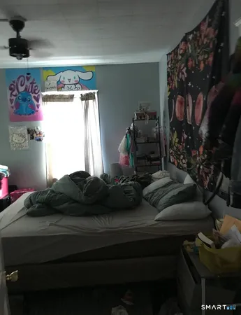 a bedroom with a bed and window