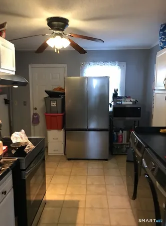 a kitchen with a refrigerator and a stove