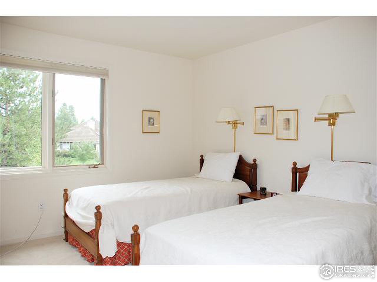 7233 Four Rivers Road Boulder, CO 80301 - Photo 7 of 12 a bedroom with two beds and a large window