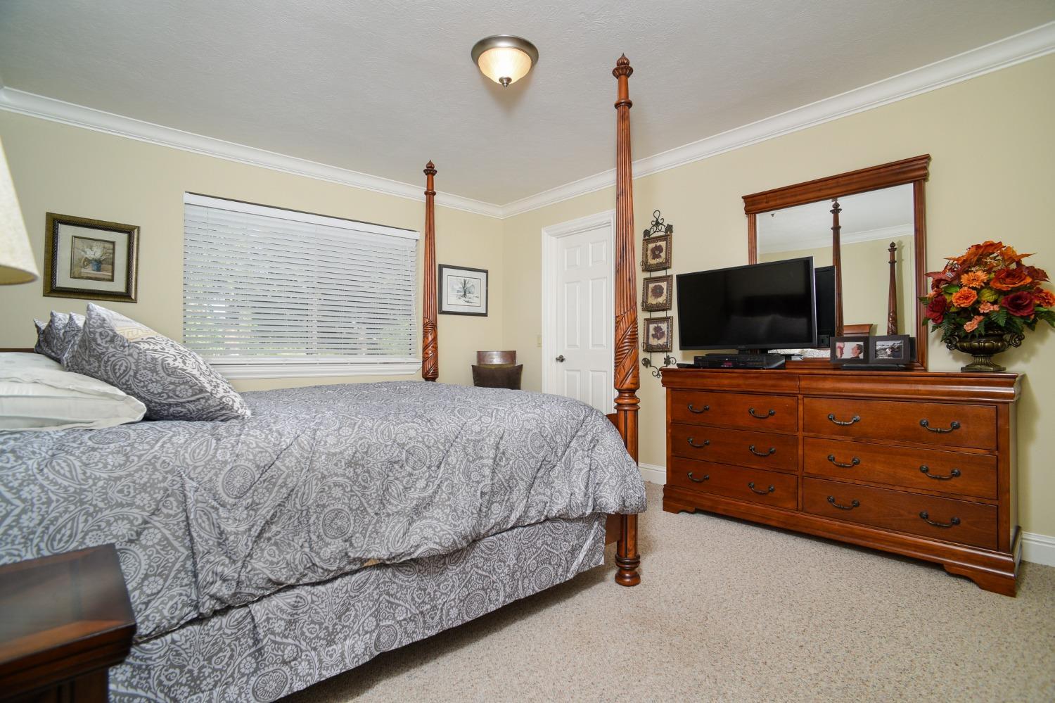 8720 Tavernor Road Wilton, CA 95693 - Photo 26 of 83 a bedroom with a bed and a flat screen tv