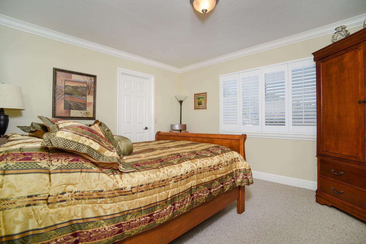 8720 Tavernor Road Wilton, CA 95693 - Photo 28 of 83 a bed sitting in a bedroom next to a window