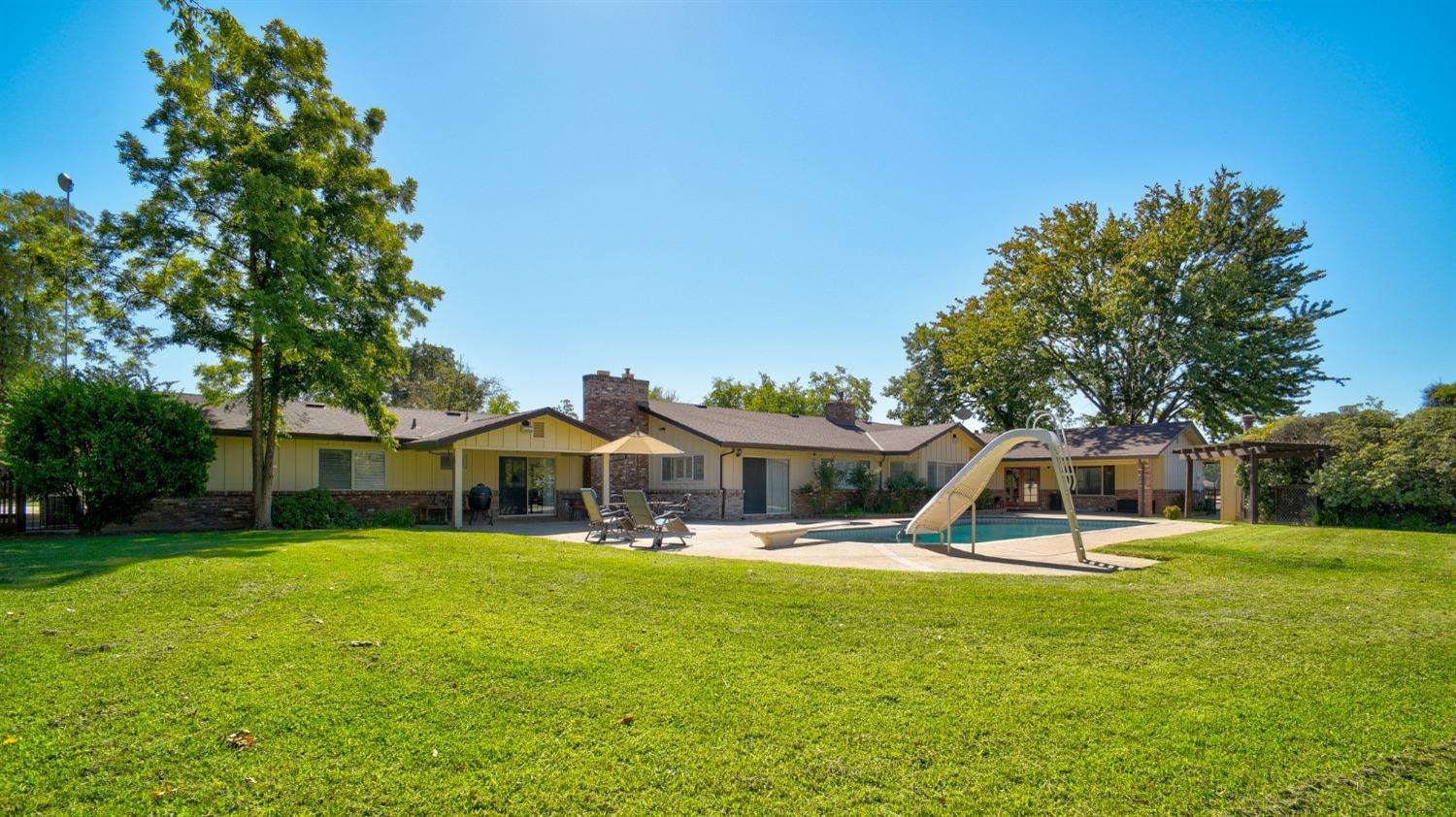 8720 Tavernor Road Wilton, CA 95693 - Photo 44 of 83 a view of a house with a yard patio and swimming pool